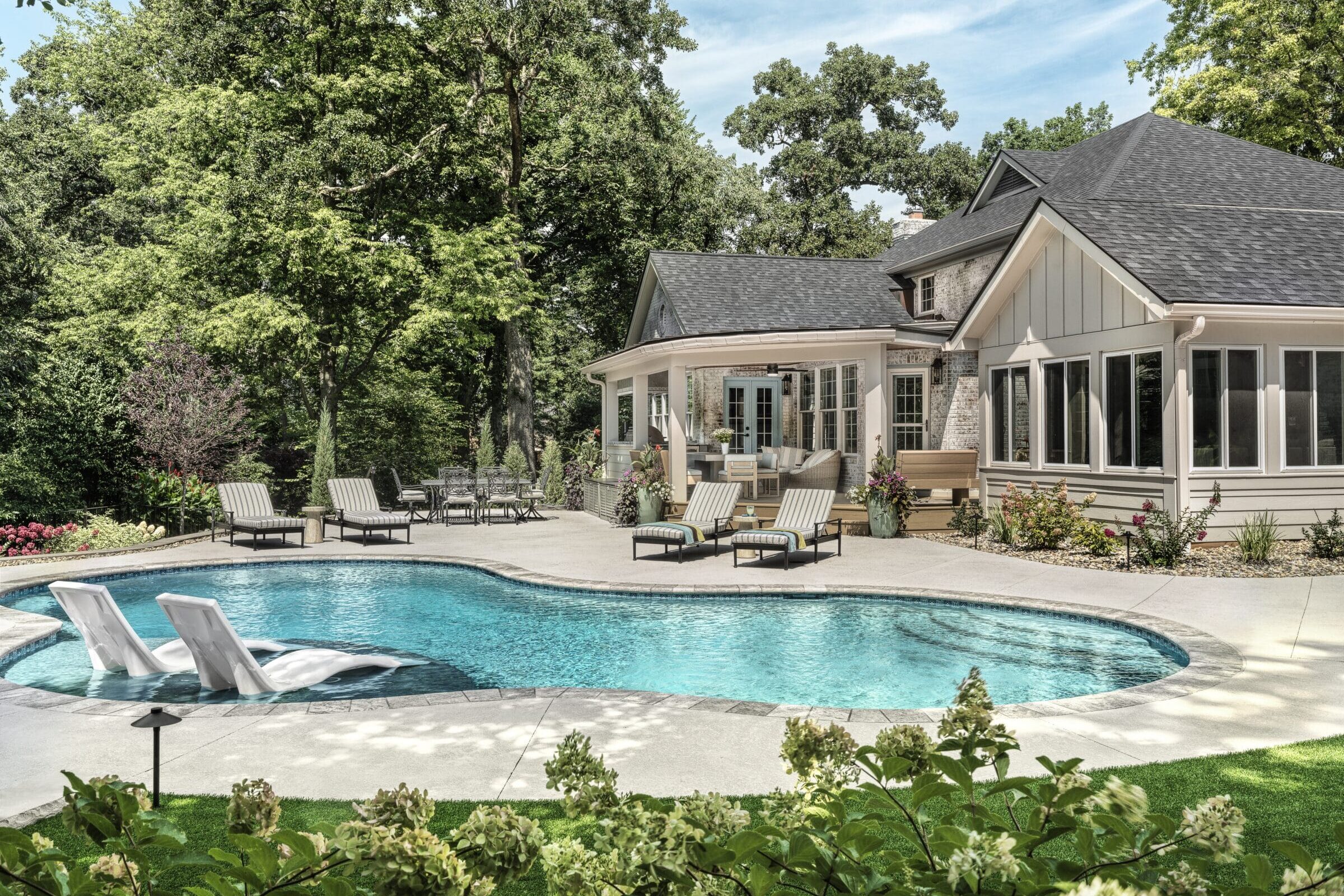 Poolside landscape design featuring a tanning ledge with lounge chairs, manicured turf putting green, and lush backyard perimeter plantings.